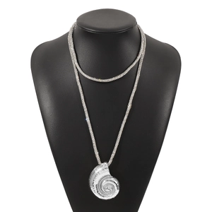 Detailed view of silver spiral conch pendant with sparkling rhinestone chain on neck model