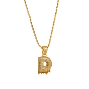 Macro shot of hip-hop gold rope chain with iced out melting letter D pendant detail