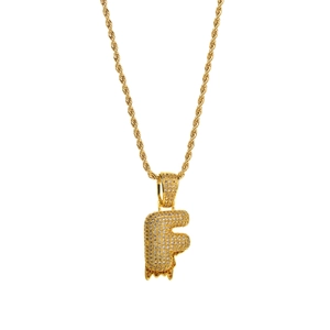 Detailed macro view of the gold-plated letter F pendant with glittering zircon inlay