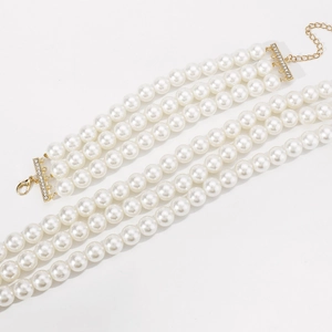 Detail of three-layer faux pearl choker with gold crystal clasp and extender