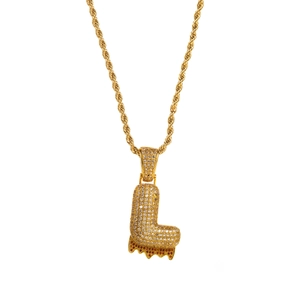 Macro shot of gold-plated hip hop letter L pendant with zircon and rope chain