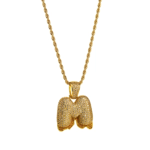Close-up of golden bubble letter M pendant with iced-out zircons and lava drip detail