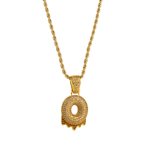 Macro shot of gold hip-hop doughnut pendant with cubic zirconia and melting oil detail