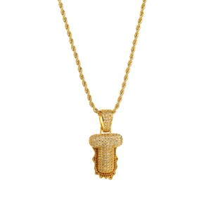 Close-up of gold rope chain with zircon-studded letter T pendant in lava drip style