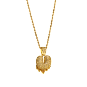 Detail of gold rope chain necklace with heart pendant and dripping orange zircon accents