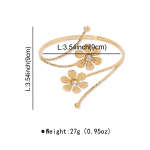Detailed view of golden flower spiral arm cuff with dimensions 9cm and 27g weight