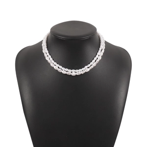Elegant double-layer white pearl necklace displayed on a black mannequin stand