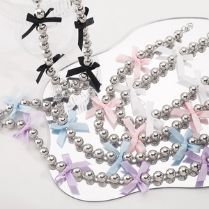 Y2K style beaded choker necklace featuring metallic silver beads and colorful silk bows