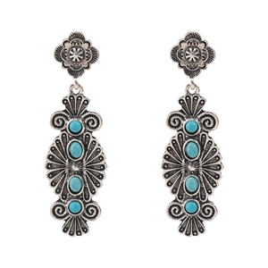 Detail of bohemian silver earrings featuring vintage floral engravings and turquoise stones