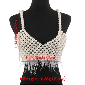Luxurious pearl body chain vest with v-neck and white feather trim on black mannequin