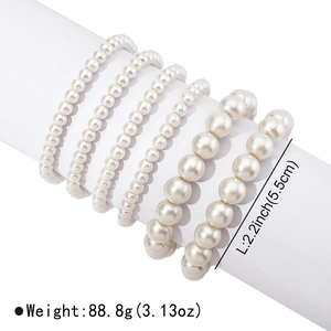 Detail view of 6-piece white faux pearl stretch bracelets with various bead sizes