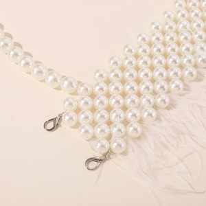 Detail of multi-row pearl choker body chain with white feather trim and silver lobster clasps
