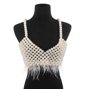 Close-up of luxury pearl beaded bralette featuring delicate white feather fringe trim