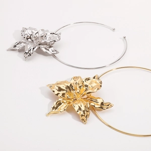 Macro shot of 3D textured gold and silver floral chokers with hammered petal details