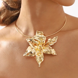 Exaggerated golden lily flower choker necklace featuring a textured liquid metal pendant