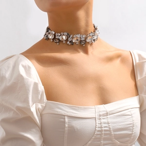 Close-up of vintage choker necklace with colorful crystals on elegant model neck
