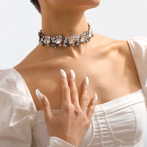 Detail view of a vintage crystal choker necklace with intricate floral rhinestone clusters