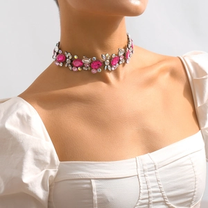 Detail of pink crystal choker necklace with intricate floral patterns and sparkling rhinestones