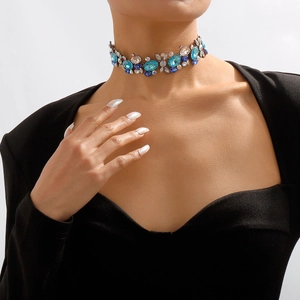Detailed close-up of a vintage crystal choker with blue rhinestones on a female model
