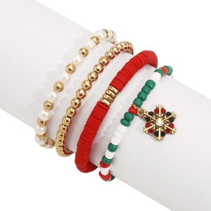 Detail of Christmas beaded bracelet set featuring snowflake charm and festive colors