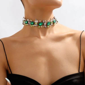 Close-up of vintage choker necklace featuring green and multicolor crystal gemstones