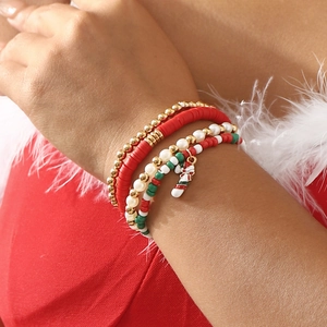 Set of four Christmas beaded bracelets with festive red green beads and candy cane charm
