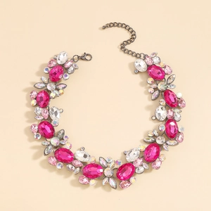 Macro detail of large pink and iridescent crystal clusters on a statement necklace
