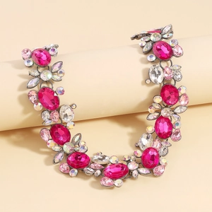 Detailed close-up of vintage necklace featuring pink and iridescent faceted crystals