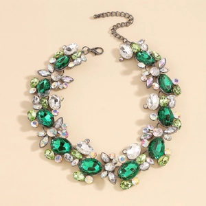 Macro view of crystal statement necklace featuring green gemstones and crystal floral clusters
