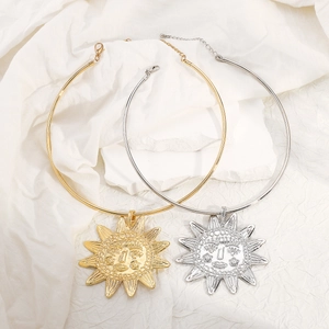 Collier ras de cou rigide avec pendentif soleil sculpté en or et argent