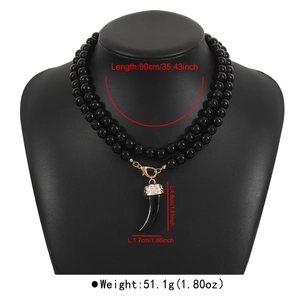 Long double-layered black beaded necklace with a wolf tooth pendant and size markings