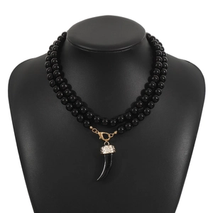 Double-layer black beaded necklace with a wolf tooth pendant and ornate silver cap