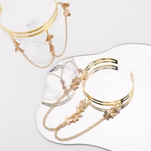 Detail of gold multi-layer butterfly tassel arm bracelet with elegant hanging chains