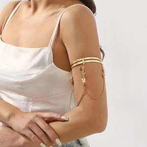 Elegant gold butterfly upper arm cuff with hanging chains and tassel charm details
