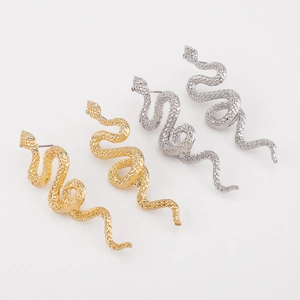 Detail view of twisted snake earrings with hammered scale texture and white zircon stone