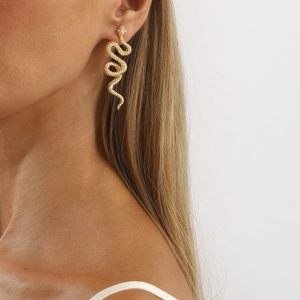 Elegant gold snake drop earrings with realistic scale texture on a model's ear