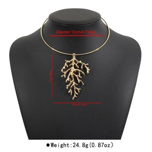 Detailed view of golden branch pendant necklace with 12cm diameter and 5cm pendant