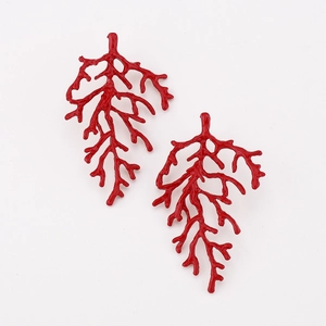 Detailed macro view of bright red coral branch earrings with polished texture
