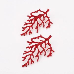 Detail view of red coral-shaped earrings with high-gloss finish and branch design