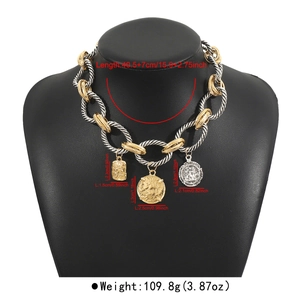 Detail of chunky twisted chain necklace with vintage coin pendants and gold-silver finish