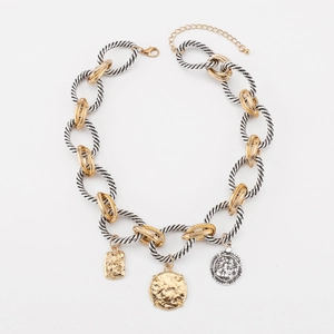 Detail of twisted chain necklace featuring two-tone mixed links and coin pendants