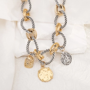 Detail of chunky cable chain necklace with gold coins and silver embossed pendants