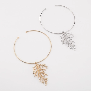 Detailed view of open coral branch collar necklaces in gold and silver finish