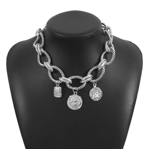 Detail of silver twisted rope chain necklace with vintage coin and relief pendants
