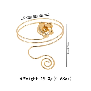 Detailed view of golden floral armlet with dimensions 8.5cm diameter and 7cm height