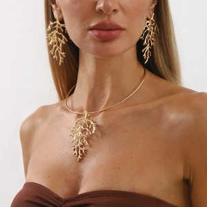 Golden coral branch jewelry set with necklace and drop earrings on a model
