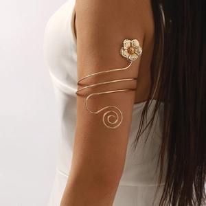 Elegant gold spiral arm cuff featuring a delicate 3D flower charm for women