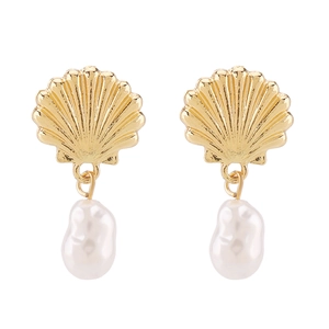 Detail of elegant gold seashell earrings with white baroque pearls in vintage French style