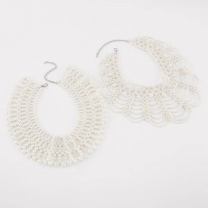 Macro shot of two white pearl beaded collar necklace designs with adjustable lobster clasps