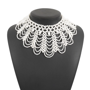 Detailed macro view of handcrafted multi-layer white pearl collar necklace in vintage style